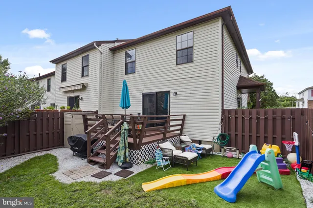 a view of a house with a backyard and a slide