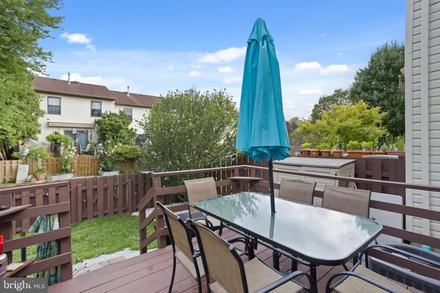 a view of a chairs and table in patio with wooden fence