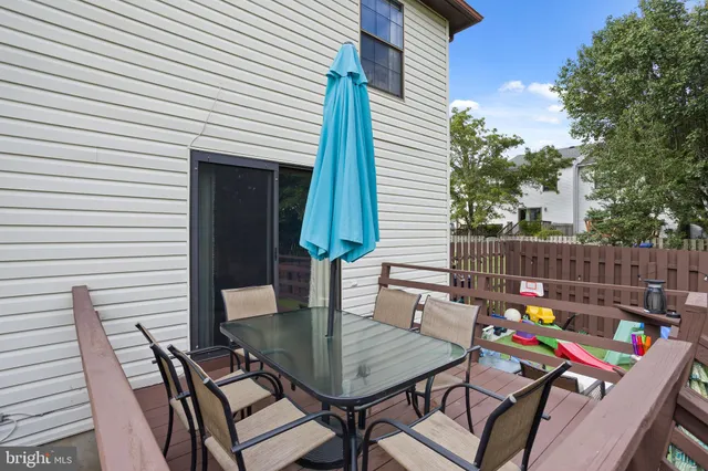 a view of a patio with a table and chairs