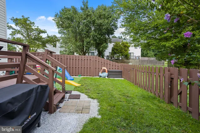 a view of a garden with wooden fence