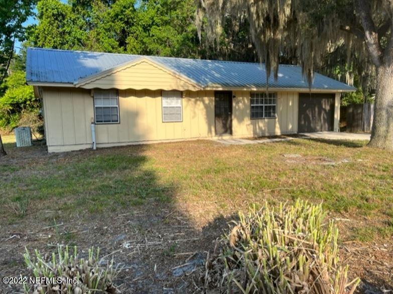 108 River Rd Drive Palatka, FL 32177 - Photo 1 of 11 a front view of a house with a garden