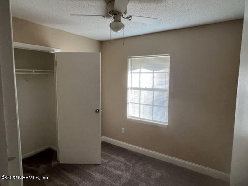 108 River Rd Drive Palatka, FL 32177 - Photo 7 of 11 an empty room with windows and fan