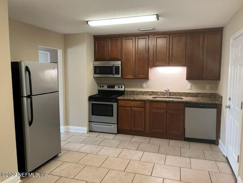 108 River Rd Drive Palatka, FL 32177 - Photo 9 of 11 a kitchen with stainless steel appliances granite countertop a refrigerator stove and microwave