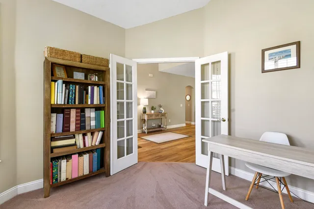 a utility room with dryer washer and a view of living room