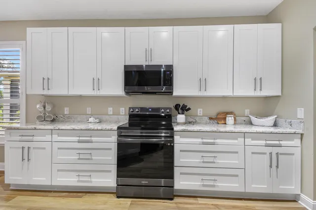 a living room with furniture and a ceiling fan