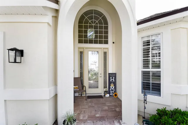a view of a dining room with furniture large windows and wooden floor