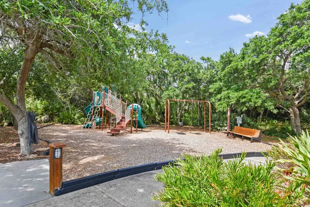 a living room with furniture a large window and a fireplace