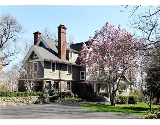 a front view of a house with a yard and potted plants