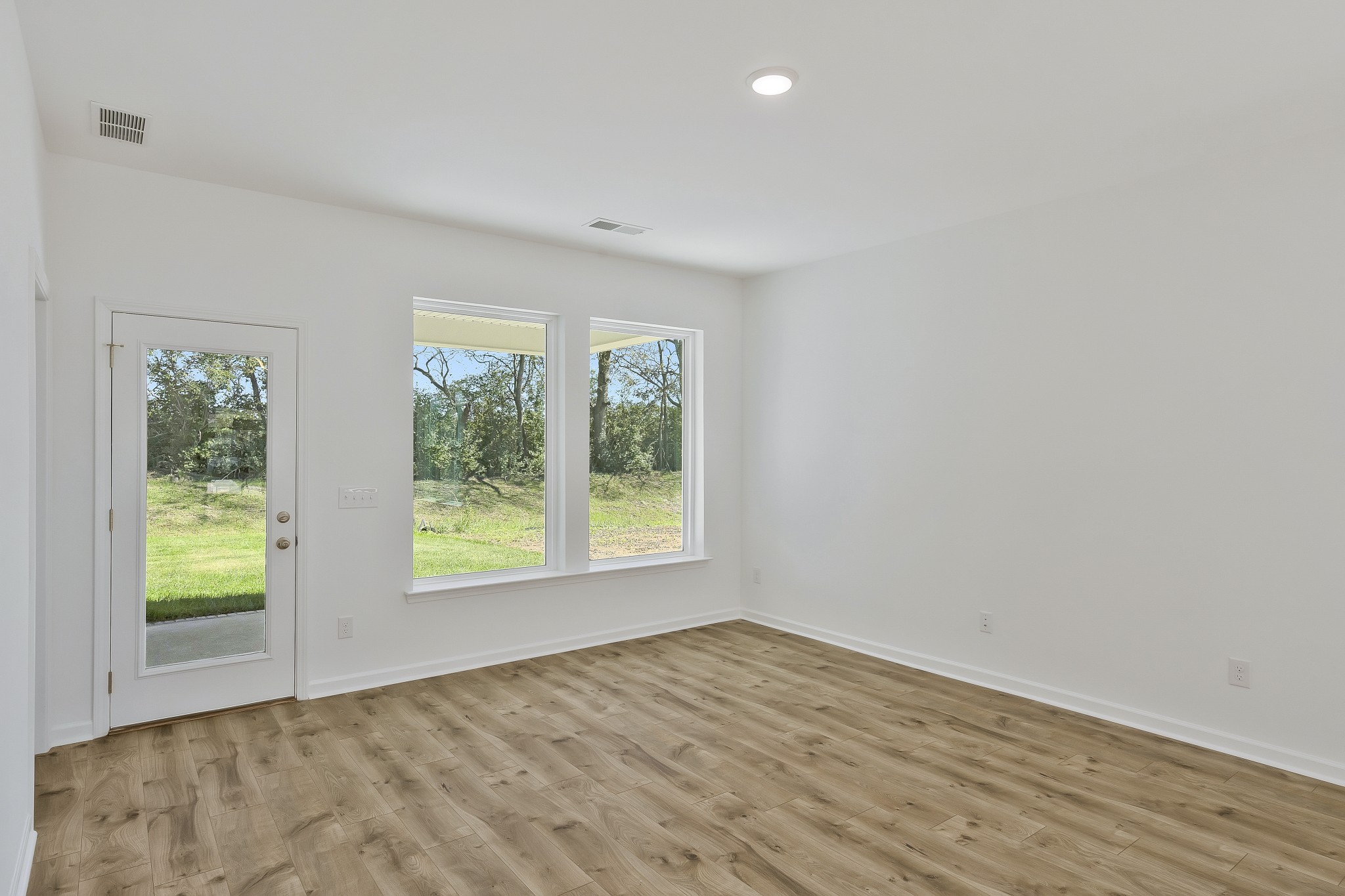 2052 Mackinac Bend Gallatin, TN 37066 - Photo 12 of 38 a view of an empty room with wooden floor and a window