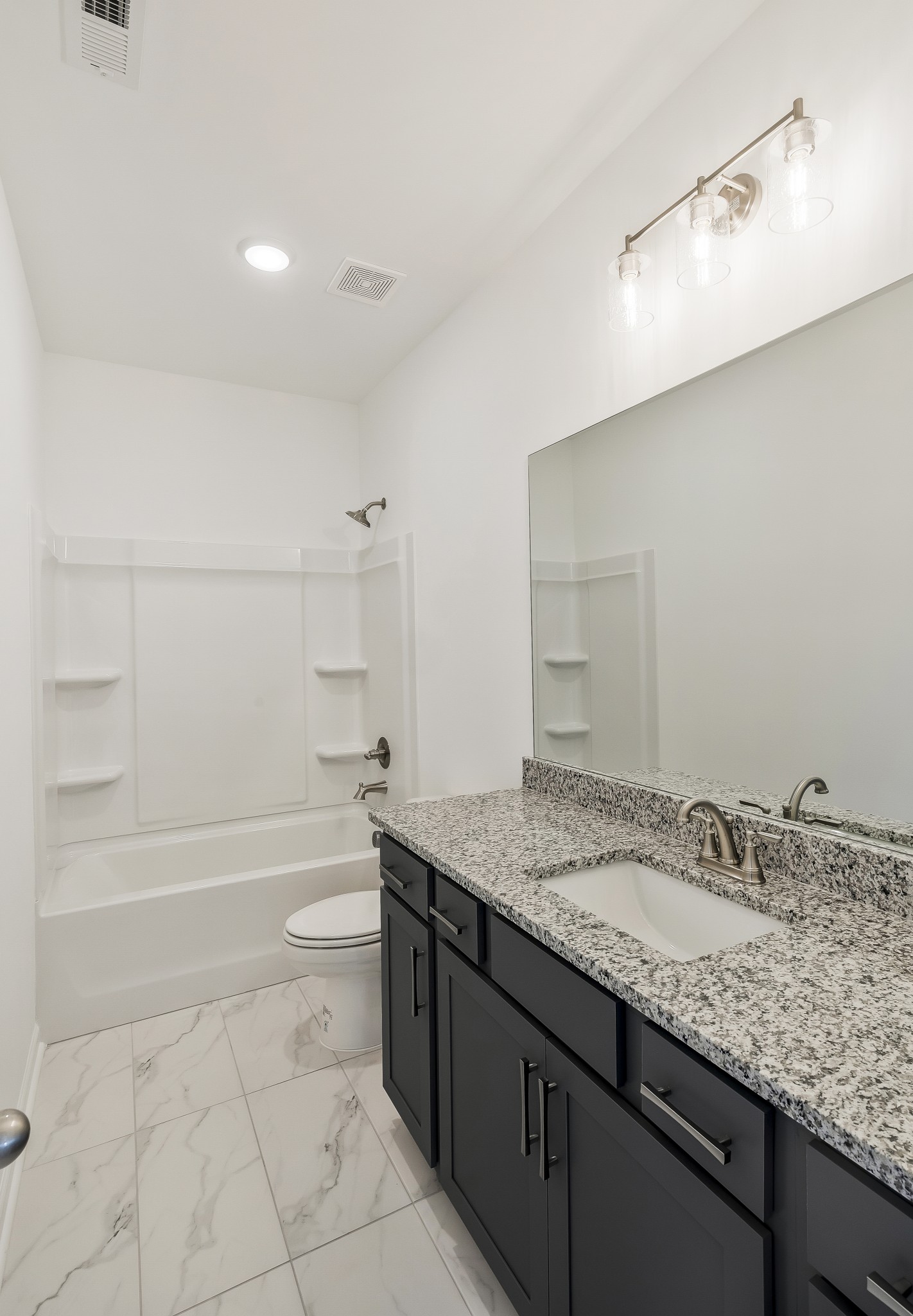 2052 Mackinac Bend Gallatin, TN 37066 - Photo 31 of 38 a bathroom with a granite countertop sink a toilet and bathtub