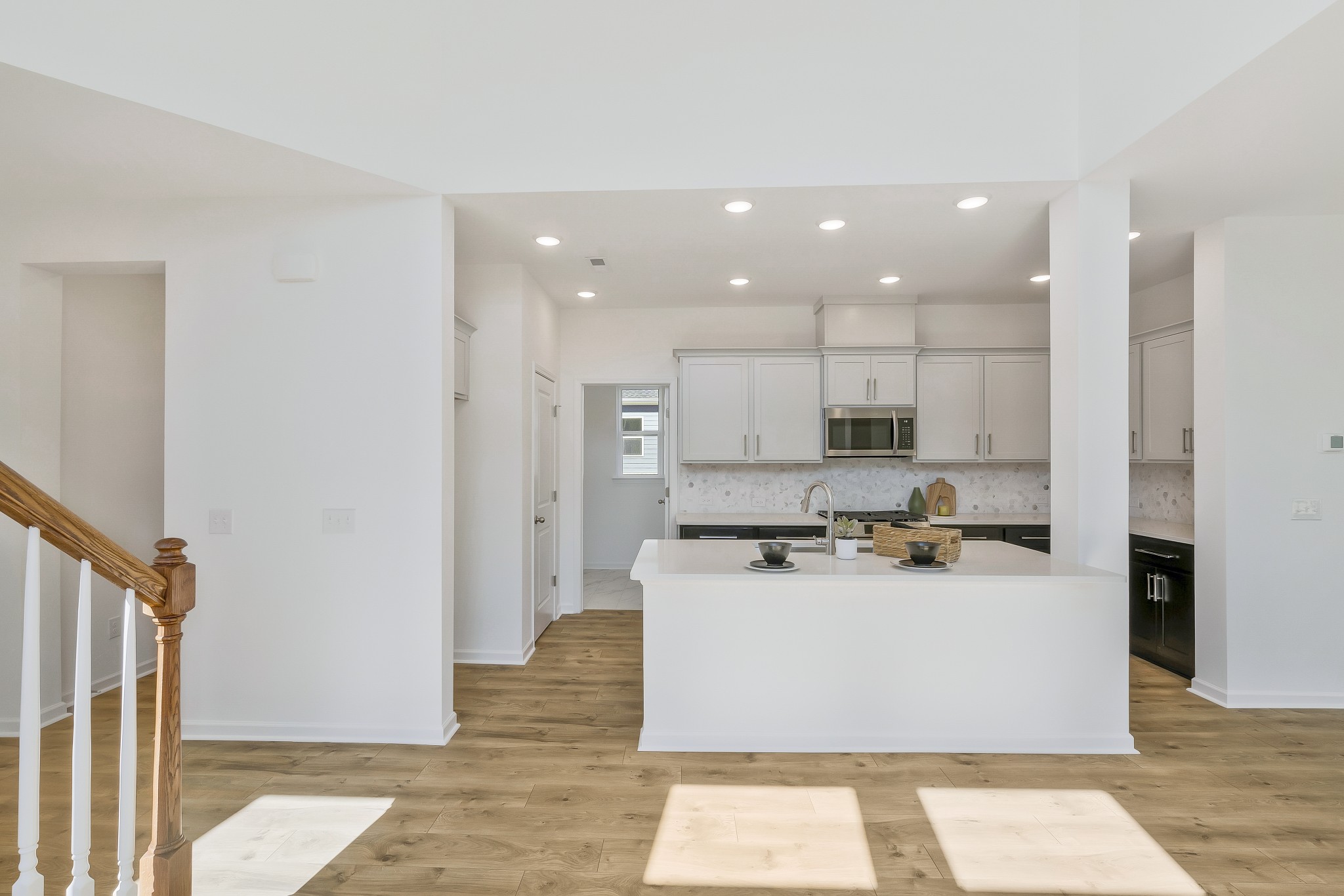 2052 Mackinac Bend Gallatin, TN 37066 - Photo 6 of 38 a kitchen with stainless steel appliances kitchen island granite countertop a stove a refrigerator a sink and white cabinets with wooden floor