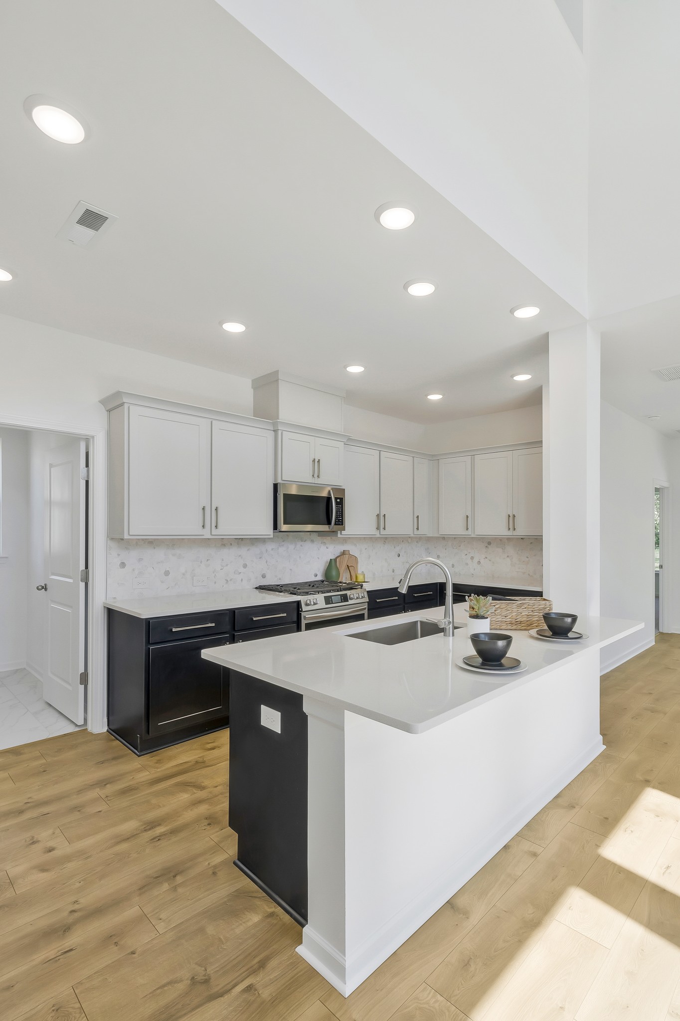 2052 Mackinac Bend Gallatin, TN 37066 - Photo 7 of 38 a kitchen with stainless steel appliances granite countertop a stove top oven a sink and white cabinets