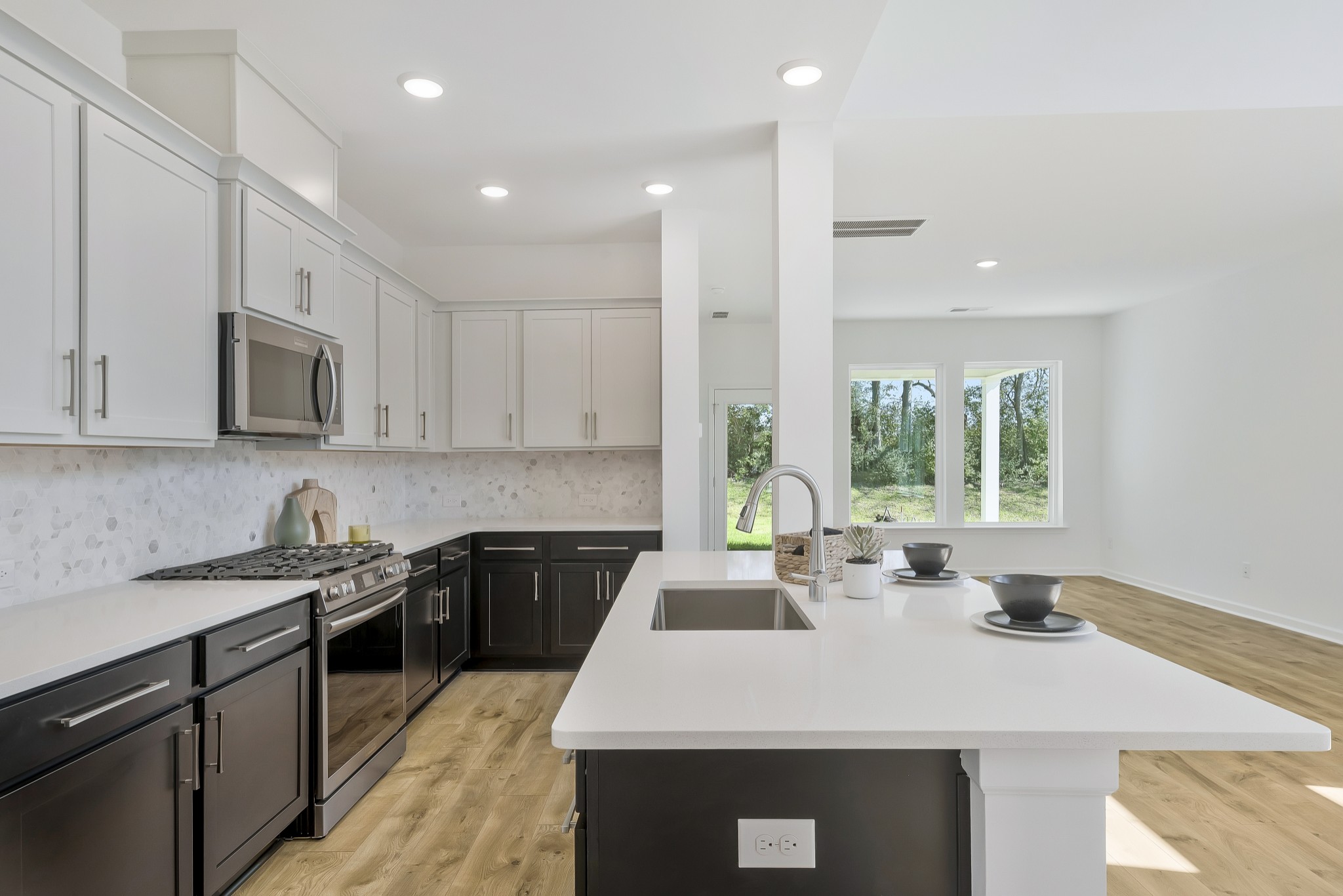 2052 Mackinac Bend Gallatin, TN 37066 - Photo 10 of 38 a kitchen with a sink a stove a microwave a center island and a window