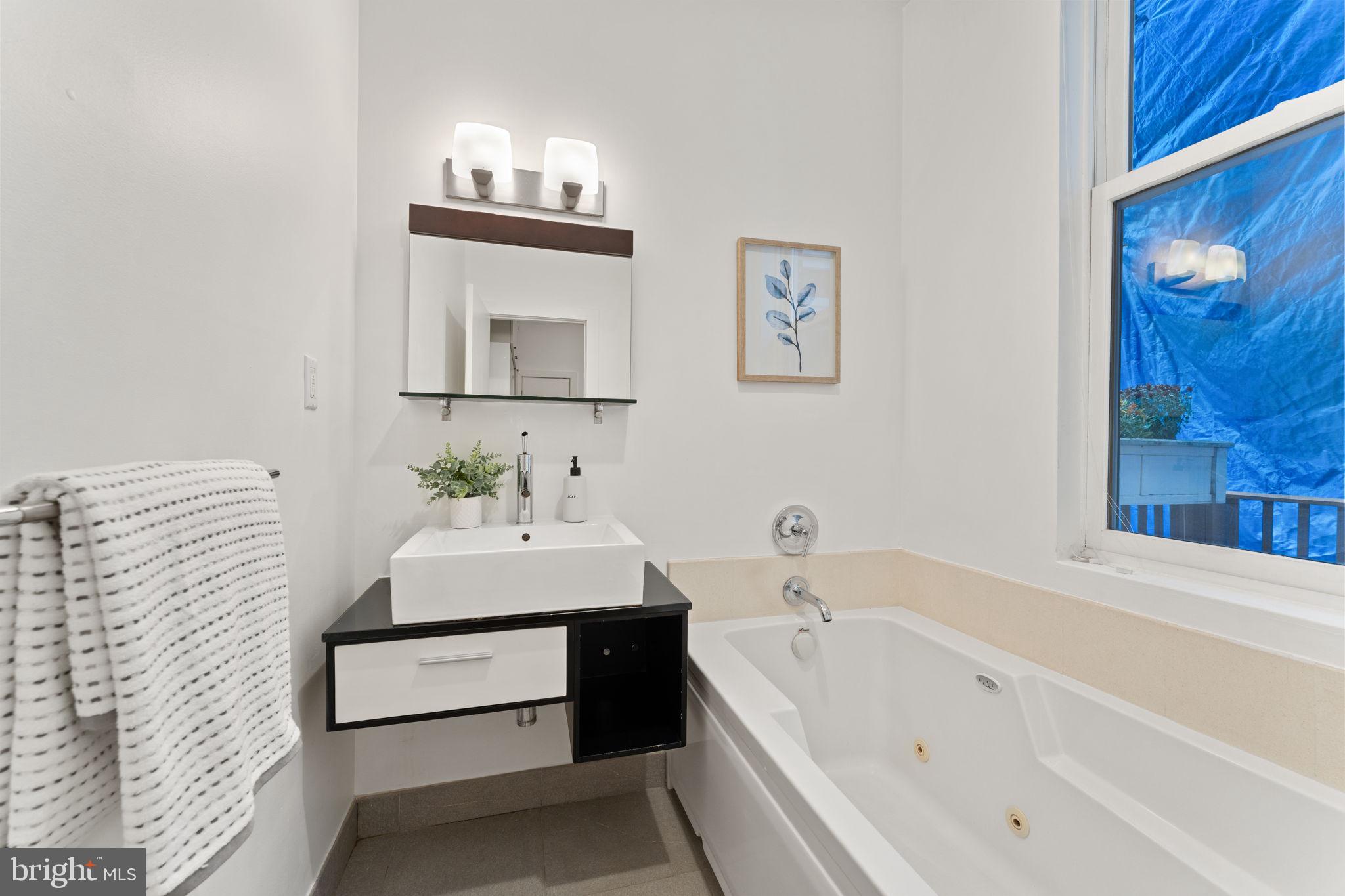 1516 R Street Northwest, Unit 3 Washington, DC 20009 - Photo 17 of 29 a bathroom with a sink and a bathtub
