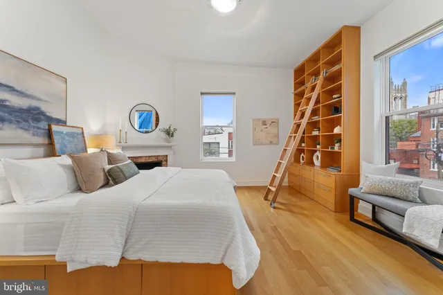 a bedroom with a bed and a wooden floor