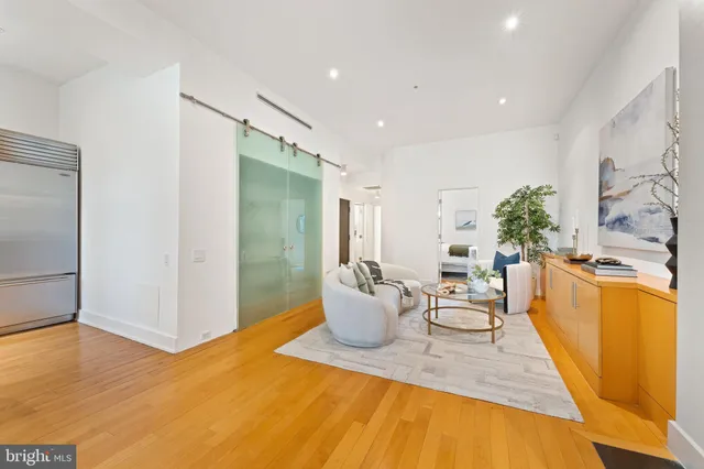 a living room with furniture a fireplace and a large window