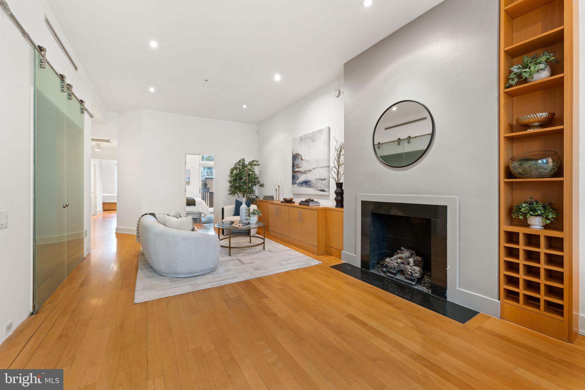 1516 R Street Northwest, Unit 3 Washington, DC 20009 - Photo 6 of 29 a living room with furniture a fireplace and a clock