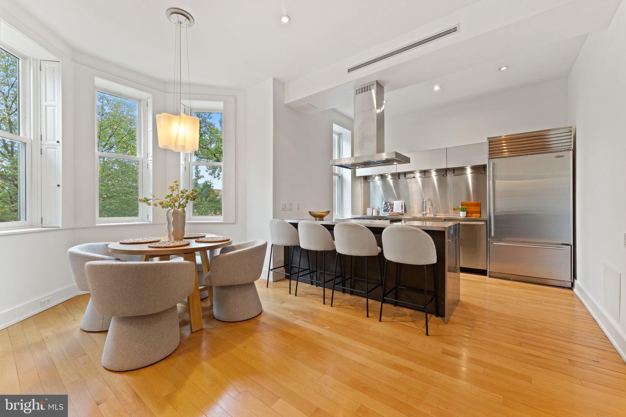 1516 R Street Northwest, Unit 3 Washington, DC 20009 - Photo 9 of 29 a living room with furniture a large window and dining table