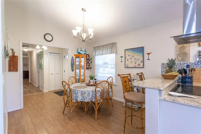 a view of a dining room with furniture and chandelier