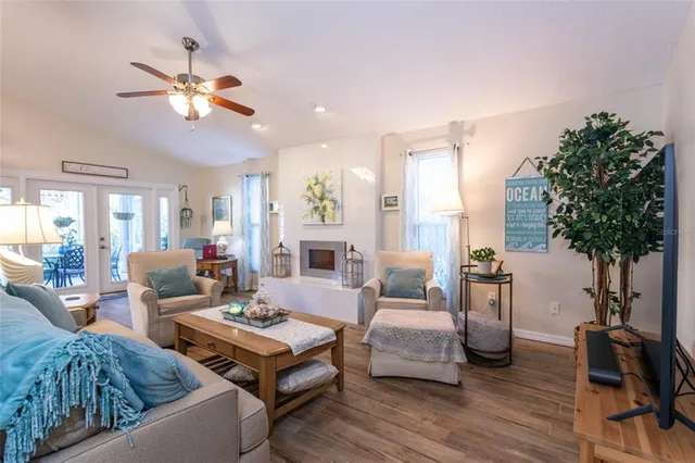 a living room with furniture and a potted plant