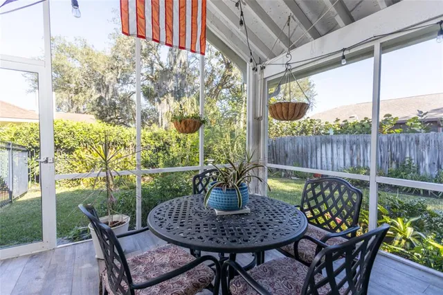 a view of a patio with a dining table and chairs