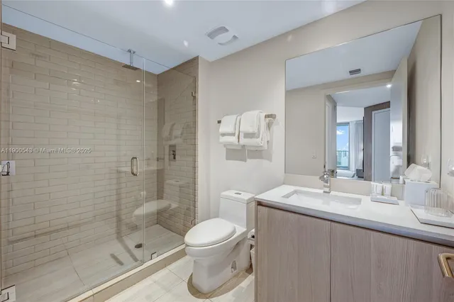a bathroom with a double vanity sink toilet tub and shower