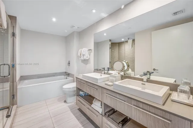 a bathroom with a bathtub and shower