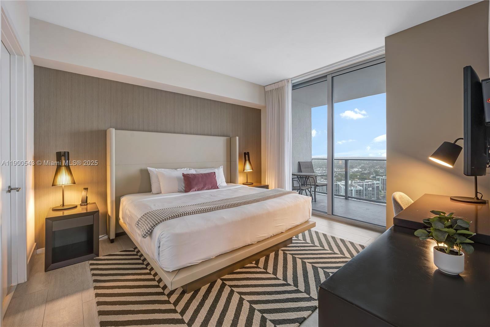 4010 South Ocean Drive, Unit R2501 Hollywood, FL 33019 - Photo 18 of 20 a bedroom with a bed and wooden floor