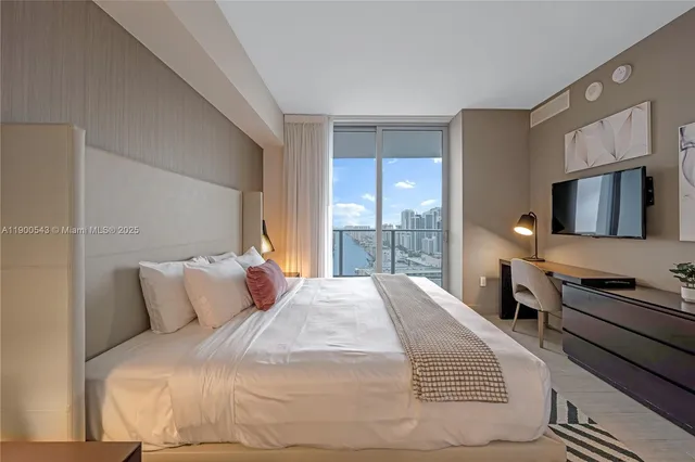 a bedroom with a bed and a dresser with mirror