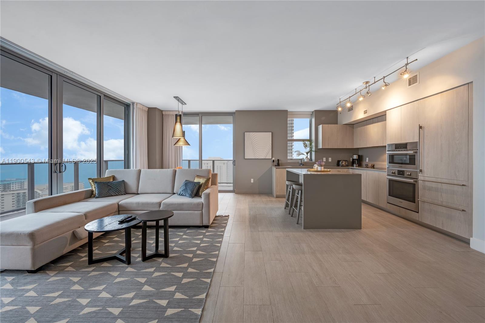 4010 South Ocean Drive, Unit R2501 Hollywood, FL 33019 - Photo 5 of 20 a living room with furniture and a kitchen view