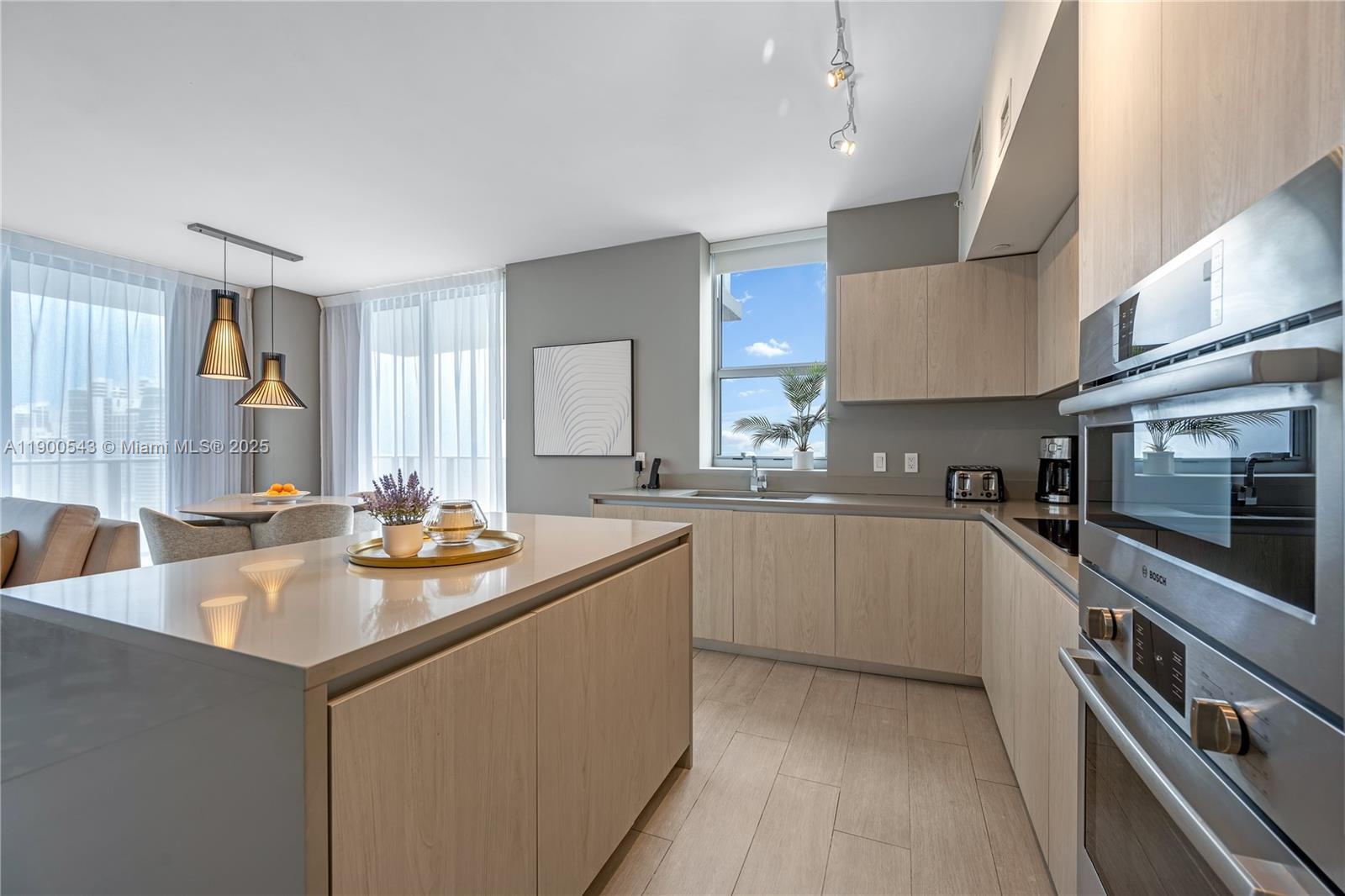 4010 South Ocean Drive, Unit R2501 Hollywood, FL 33019 - Photo 9 of 20 a kitchen with counter and windows