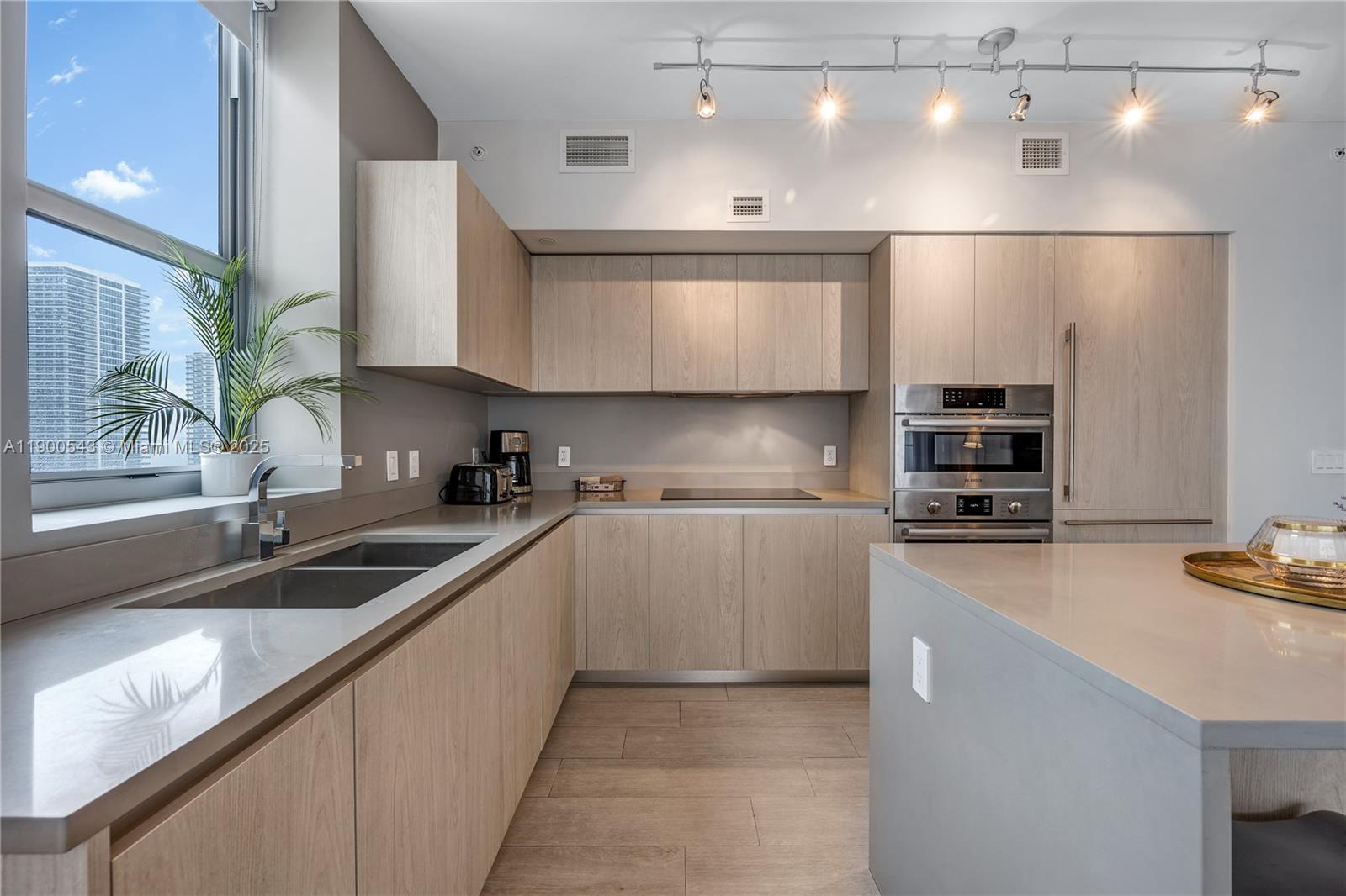 4010 South Ocean Drive, Unit R2501 Hollywood, FL 33019 - Photo 10 of 20 a kitchen with stainless steel appliances granite countertop a sink stove and refrigerator