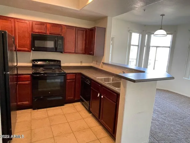 a kitchen with a stove a sink and a microwave