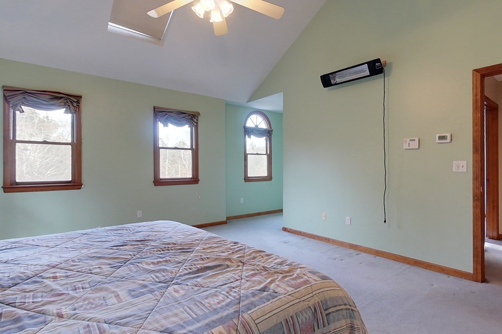 9 Pumpkin Brook Road Shirley, MA 01464 - Photo 23 of 37 a bedroom with a bed and a chandelier