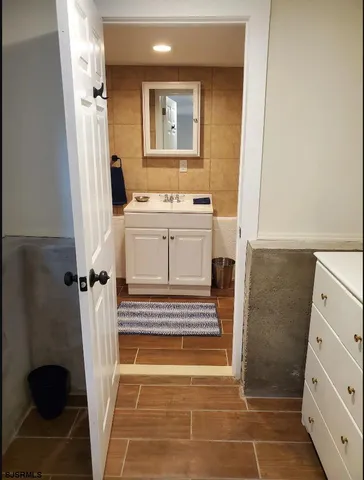a bathroom with a sink toilet and window