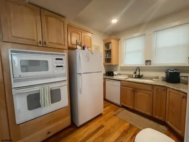 a kitchen with a sink cabinets and a window