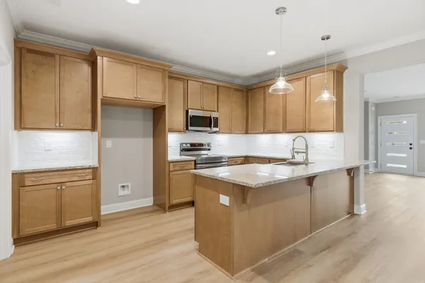 a kitchen with stainless steel appliances granite countertop a sink stove and refrigerator