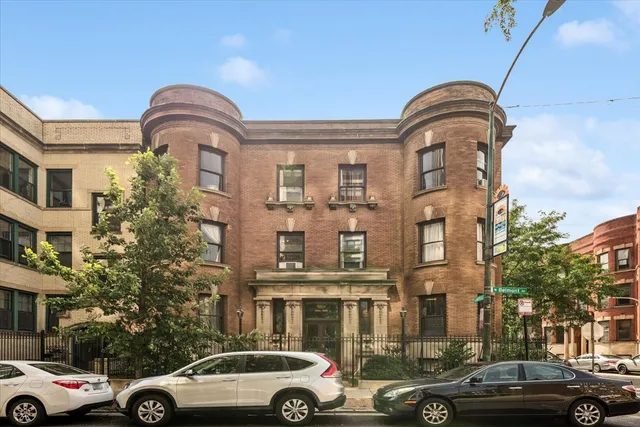 a couple of cars parked in front of a building
