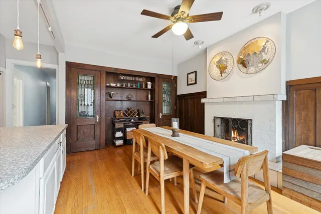 a living room with a table chairs and a fireplace