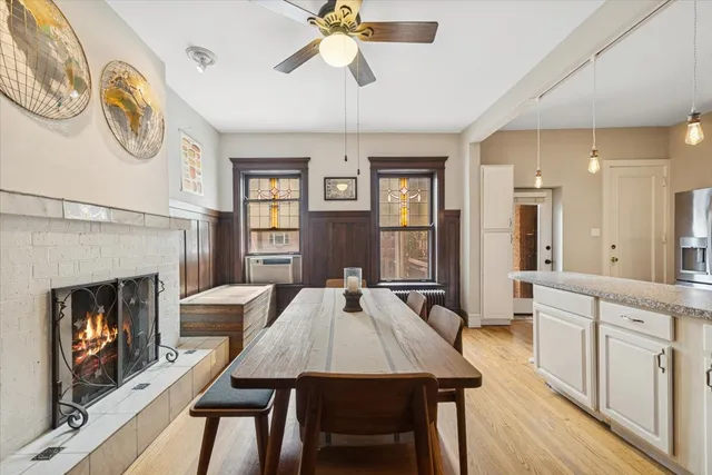 a view of a a dining room with furniture window and wooden floor