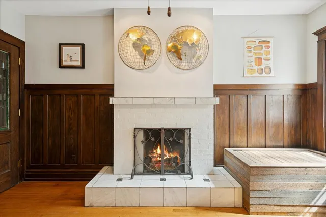 a living room with a table and a fireplace