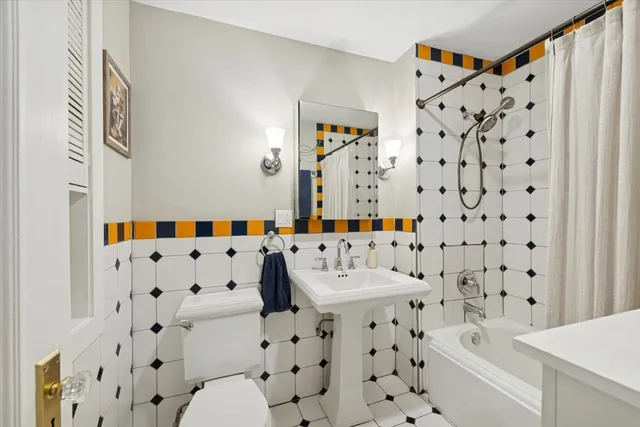 a bathroom with a bathtub and a shower curtain