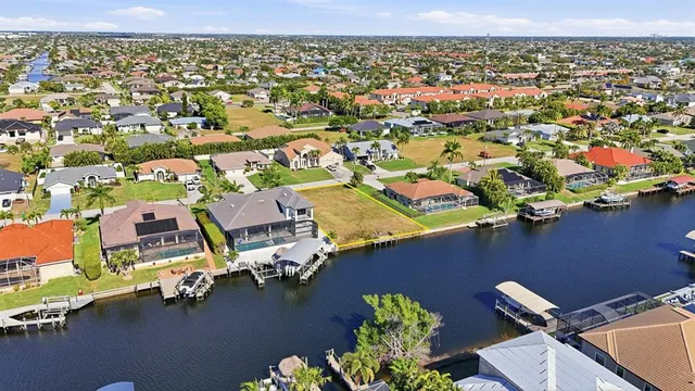an aerial view of residential houses with outdoor space and river