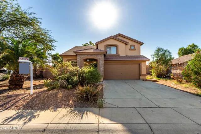 a front view of house with yard and trees around