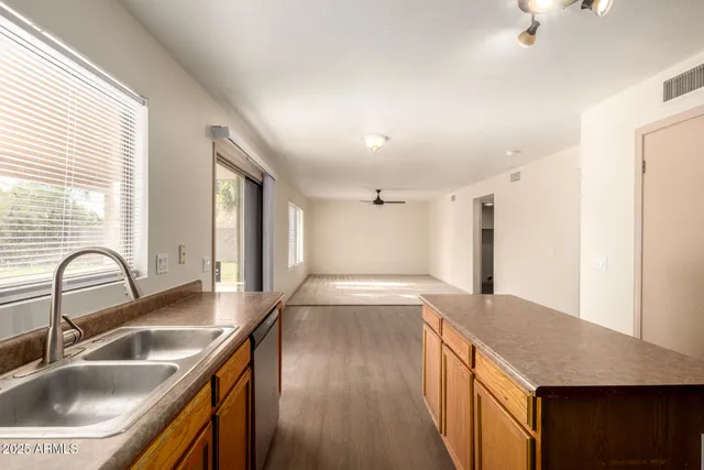 a kitchen with stainless steel appliances granite countertop a sink a stove and a refrigerator