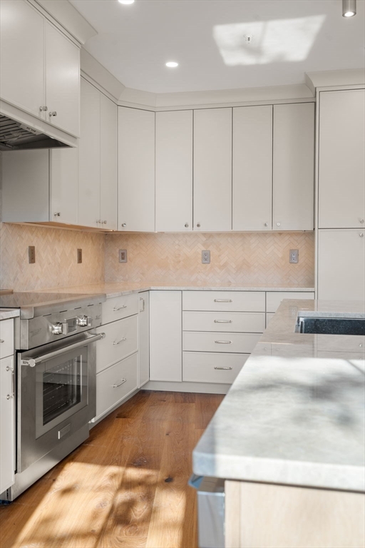 34 Vinton Street, Unit 3 Boston, MA 02127 - Photo 11 of 29 a kitchen with granite countertop a sink a stove and cabinets