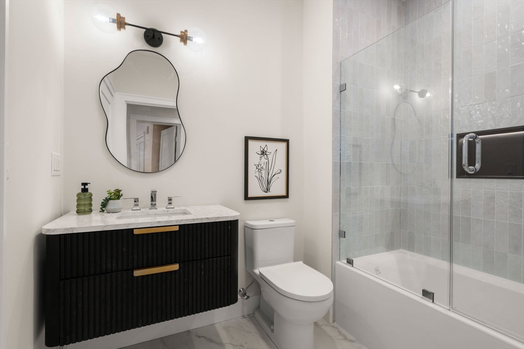 34 Vinton Street, Unit 3 Boston, MA 02127 - Photo 16 of 29 a bathroom with a toilet sink and mirror