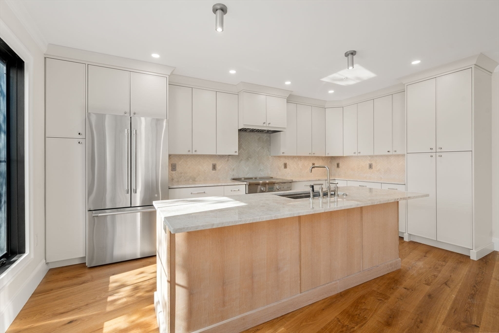 34 Vinton Street, Unit 3 Boston, MA 02127 - Photo 5 of 29 a kitchen with kitchen island a sink stainless steel appliances and cabinets