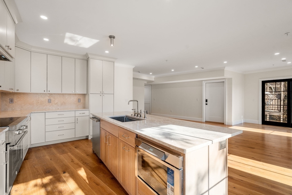 34 Vinton Street, Unit 3 Boston, MA 02127 - Photo 6 of 29 a kitchen that has a sink and a stove in it