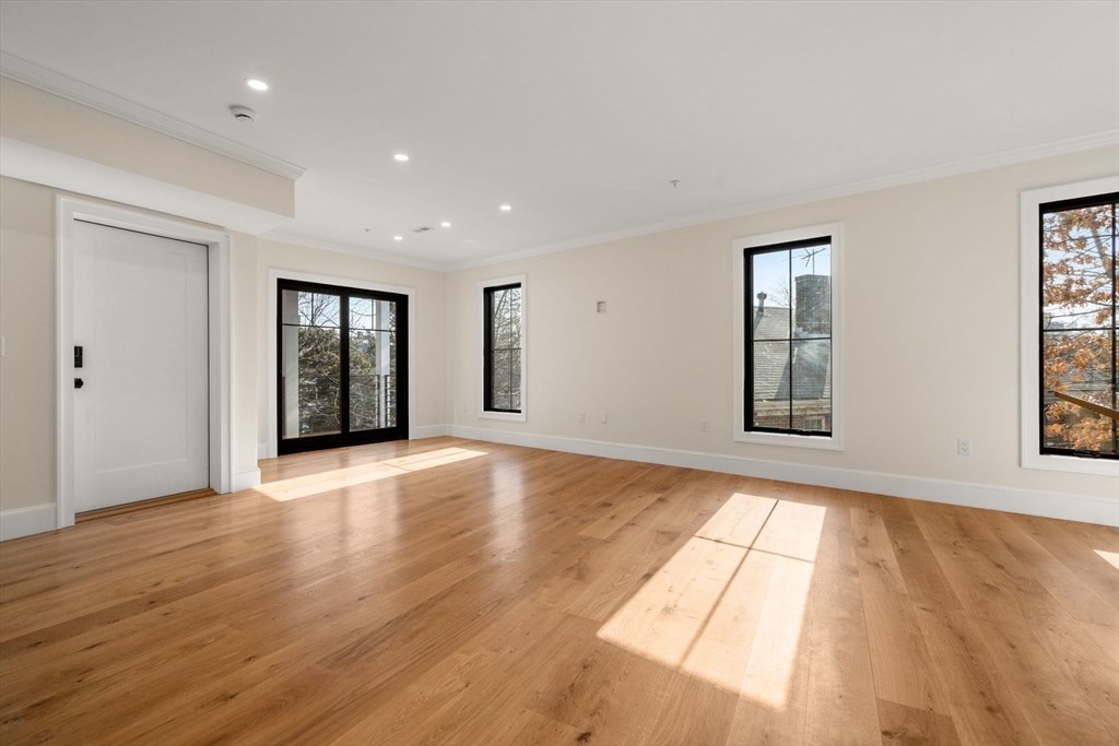 34 Vinton Street, Unit 3 Boston, MA 02127 - Photo 7 of 29 a view of an empty room with wooden floor and a window